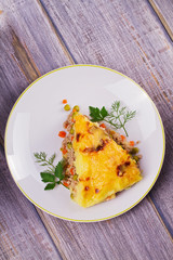 Meat, potato, cheese, carrot, onion and green peas casserole. Traditional shepherd pie. View from above, top studio shot