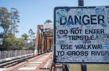 Danger sign before abandoned rail bridge