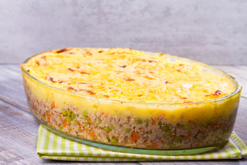 Meat, potato, cheese, carrot, onion and green peas casserole. Traditional shepherd pie