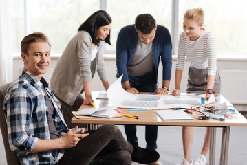 Handsome joyful man sitting in the chair