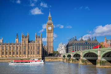 Fototapeta na wymiar Big Ben and Houses of Parliament with boat in London, England, UK