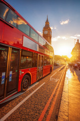 Fototapeta na wymiar Big Ben with double decker bus against colorful sunset in London, UK