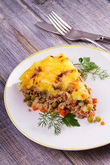 Meat, potato, cheese, carrot, onion and green peas casserole. Traditional shepherd pie