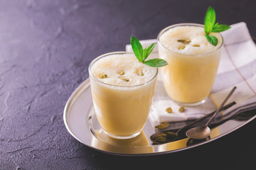 Traditional Indian mango lassi with cardamon, mint, vanilla and saffron