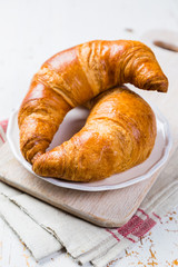Croissants on rustic wood background