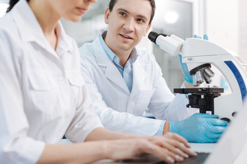 Handsome man looking at his assistant