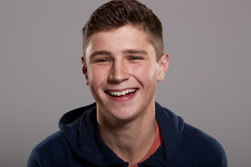 Teenage boy smiling to camera, head and shoulders portrait © Monkey Business