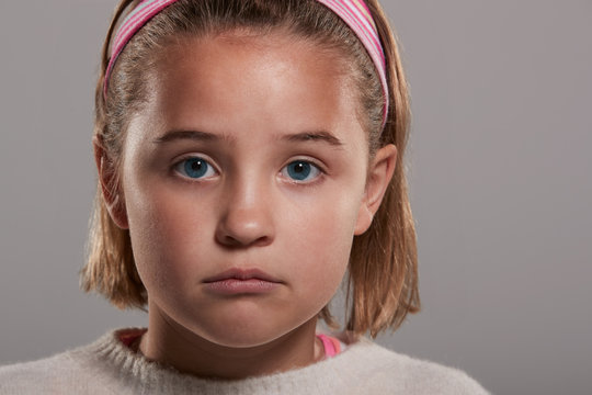 Sad Nine Year Old Girl Looking To Camera, Close Up Head Shot