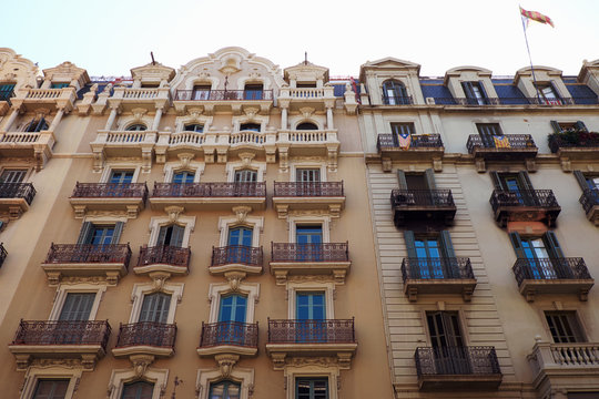 BARCELONA - JULY 29, 2016: Turn of the century building facades in the Gothic Quarter, low angle view