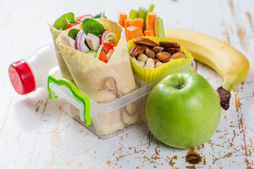 Lunch to go with tortilla wraps and vegetables