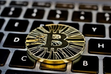 Gold bitcoin coin on the keyboard