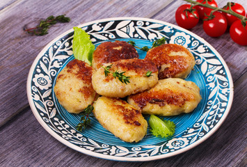 Fish patties or cakes on blue plate. Fritters of fish. Healthy snack or take-away lunch bites