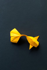 Handmade paper craft origami gold koi carp fish on black background.Top view