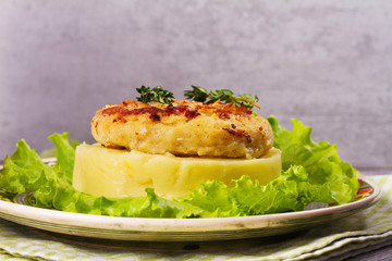 Fish cake with mashed potato and lettuce