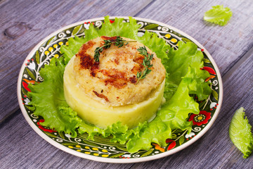 Fish cake with mashed potato and lettuce