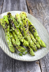 Barbecue green Asparagus as close-up on a plate .