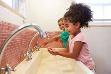 Pupils At Montessori School Washing Hands In Washroom