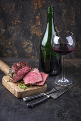 Barbecue Wagyu Point Steak with a Glass of Red Wine as close-up on an old metal sheet © HLPhoto