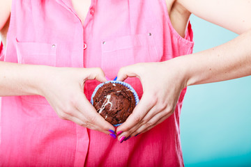 Woman hands holding muffin