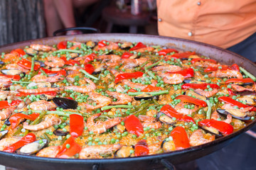 Traditional spanish rice paella with seafood. Mixed seafood stir fried spicy and salad