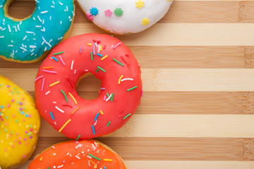 Donuts on a wooden background. Junk food. Fast food.