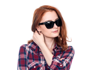 Obraz premium Close-up portrait of a red-haired beautiful woman wearing sunglasses
