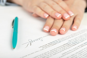 Woman hand signing a contract