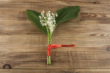 Lilies of the valley on a wooden background