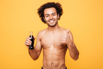 Fototapeta premium Man holding bottle with liquid and showing thumbs up gesture