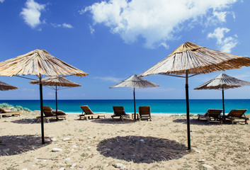 season on sandy beach near deep blue sea