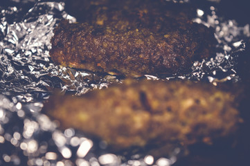 kofta kebabs on aluminum foil paper, selective focus