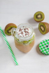 Fresh healthy fruit smoothies from kiwi, banana, pear and apple in a jar on a white background. Soft focus. Vegetarian food