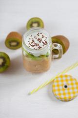 Fresh healthy fruit smoothies from kiwi, banana, pear and apple in a jar on a white background. Soft focus. Vegetarian food