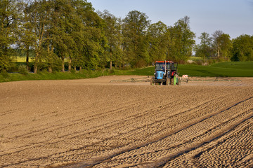 Tractor, photographed in the agricultural field during the processing of Pesticides, Poland 