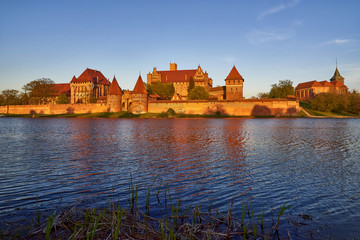 Malbork Castle in Poland, medieval fortress of Teutonic Knights Order, view across Nogat River, UNESCO World Heritage Site - panorama 