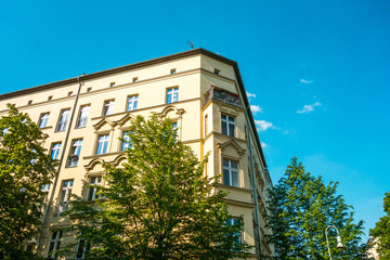 beautiful corner house with green trees