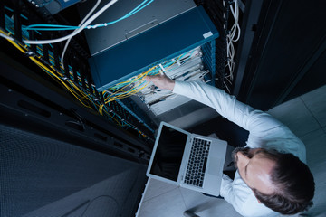 Top view of a technician holding a laptop