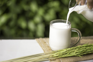 Pouring milk to the glass.