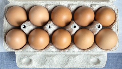 Packing eggs in a cardboard box top and close-up view