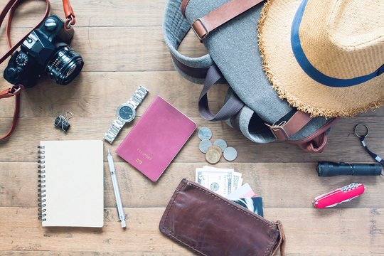 Overhead view of man's accessories, Traveler items on wooden background. Travel concept