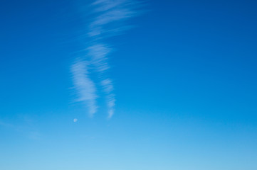 Lined cloud formation with moon