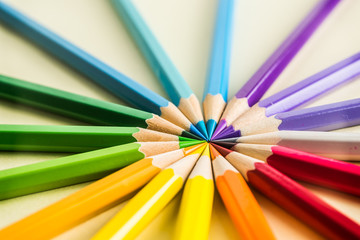 Fototapeta premium Business concept - Top view of color pencil circle on yellow paper background, teamwork, united and communication concept
