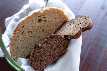 Basket of fresh white and black bread 