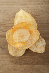 Potato chips on a wooden background