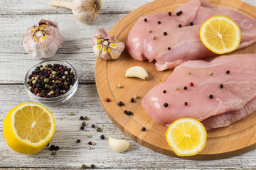 Raw chicken breasts with lemon pepper and garlic