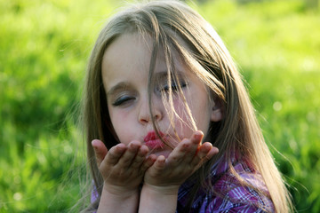 Little girl sends an air kiss