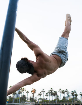 Anonymous man exercising on sports ground