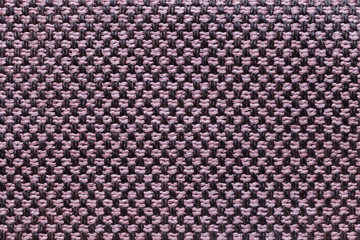 Pink and black textile background with chess pattern, closeup. Structure of the fabric macro.