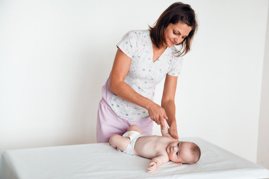 Woman doctor makes the baby a gentle massage. Children's massage.