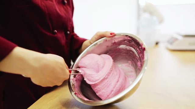 chef cooking macaron batter at confectionery